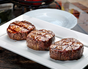 Three steaks roasted on the grill