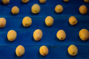 apricots on a blue wooden background