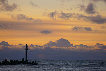 Obraz na płótnie Canvas Sunset by the sea at the lighthouse. Copy space. 
