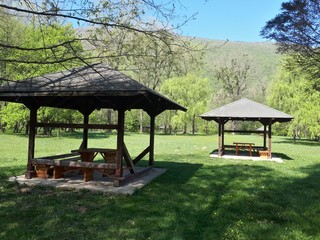 Small wooden huts and picnic tables in the park