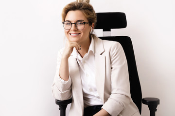 Happy businesswoman sitting on the office chair