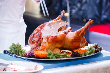 the cook cuts the fried turkey