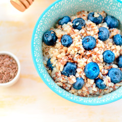 Healthy romantic breakfast with pumpkin porridge and berries at village summer house