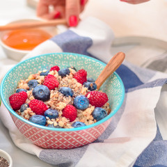 breakfast buckwheat porridge with raspberries and blueberries, good morning concept