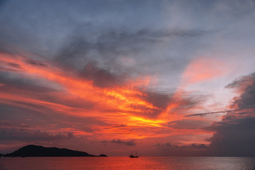 Ship in the sea against the backdrop of a fiery sunset sky. thailand.