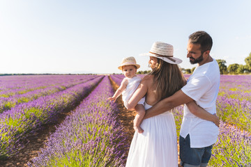 Happy Family Having Fun in a Field of Flowers.