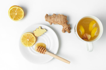 Tea with ginger, lemon and honey on a white isolated background
