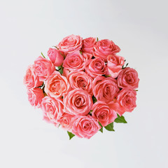 Beautiful bunch of fresh pink roses in full bloom on white background.