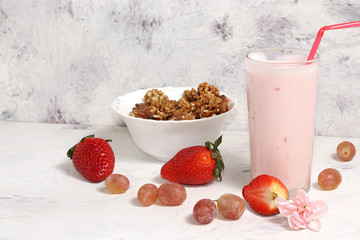Useful breakfast, food for children, strawberry yogurt, smoothies and granola, on a light table. The concept of healthy and natural food. selective focus