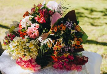 A lot of bouquets of colorful fresh flowers in a close-up package. Photography, concept.
