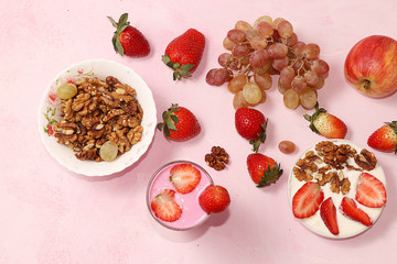 Useful breakfast, food for children, strawberry yogurt and granola, on a bright table. The concept of healthy and natural food. selective focus