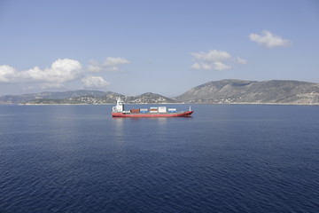 A ship loaded with containers drifts into the sea off the coast of the island.