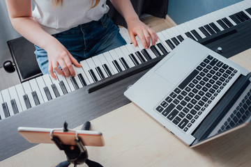 Coronavirus. Quarantine. Online piano music learning with a laptop, education and remote work....