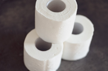 Close-up of the last  3  pieces of   toilet paper rolls products for sale   at  the  store shelf .