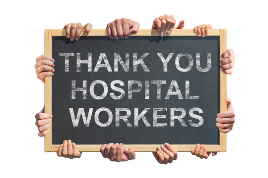 A lot of hands are holding a poster with the inscription " Thank you hospital workers " . Concept of gratitude to medical workers during the coronavirus pandemic