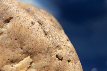 macro close-up of a stone, blue backgroundA