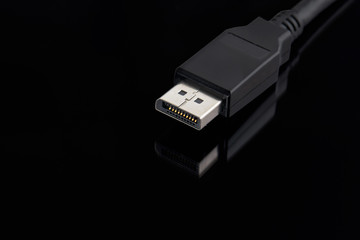 display port cable plug close up over black background. desktop gaming and tv concept.