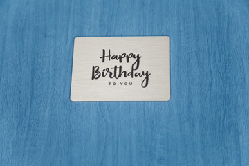Photobook, photoalbum in blue leather cover with metallic shield and inscription Happy Birthday to you. Close up