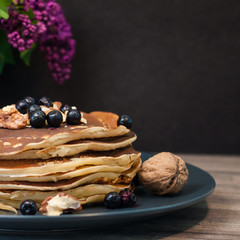 .morning breakfast pancakes .fritters with honey nuts and currants lilac copy space