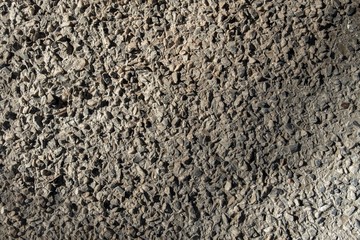 gray crushed stone with shadows. rough surface texture