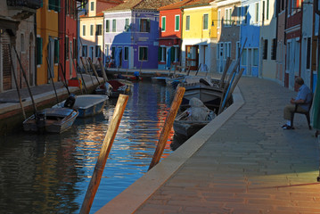 Fototapeta na wymiar Reflections in the water of Murano isle in Italy