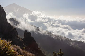 Mystical view of volcano Teide through the clouds lit by the sun, Tenerife, Canary Islands, Spain.