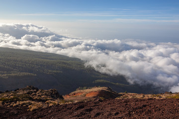 Aerial view from a volcano's slope at the clouds level in the Teide National Park, Tenerife, Canary Islands, Spain.