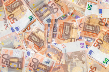 Fifty Euro banknotes background of Euro currency in Europe. Financial colorful background. Concept of printing money from the European mint and the European Central Bank ECB.