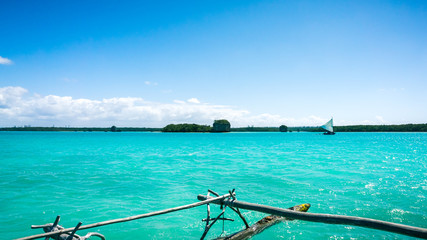 Fototapeta premium traditional caledonian sailing boat on turquoise water in Upi bay