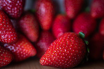 background from red strawberries with freshly picked leaves, directly above