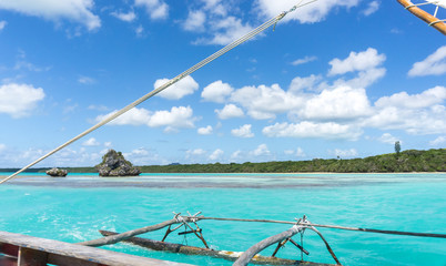 Fototapeta premium boat trip on a traditional caledonian sailing boat in Upi bay. typical rock in the turquoise sea