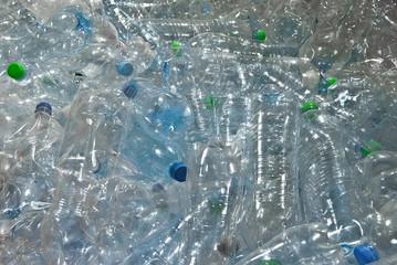 Many plastic bottles are dumped. Texture of transparent bottles of water. Concept of environmental pollution and environmental problems.