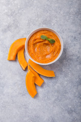 Bowls with healthy baby food on color background. Purees, made of fresh organic pumpkin flay lay, top view, concept. Kids meal