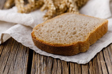 Freshly baked sliced rye bread on wooden cutting board