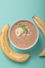 Bowls with healthy baby food on color background. Purees, made of fresh organic banana flay lay, top view, concept. Kids meal