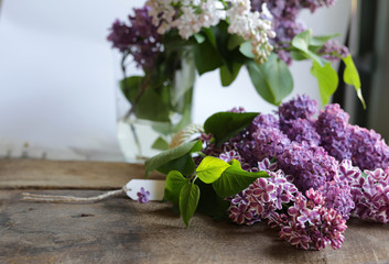 Spring beautiful bunch of purple flowers. Lilac flowers on old antique brown rustic wood background. Top view, flat lay. Banner, card, poster, rustic concept. Mothers day card
