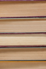 chaotic stack of old books background, selective focus