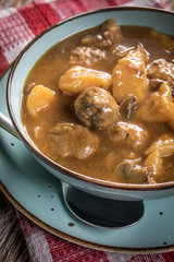 Meatballs in gravy with cast noodles.