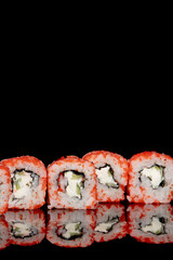 Philadelphia roll with salmon, cheese and cucumber on a black background with reflection. Sushi Philadelphia