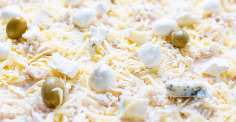 Close up image of cheese pizza ready for baking