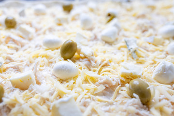 Close up image of cheese pizza ready for baking