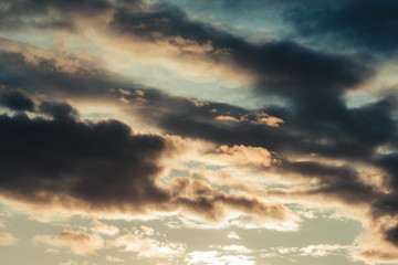 Sunset Sky with Dark Clouds. Dawn Background with Rain Clouds Lit by Sun. Bright Sky Landscape. Dramatic View. Night Cloudscape. Gloaming, overcast