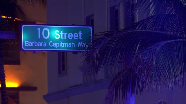 Night video Miami Beach 10th street sign with palm trees