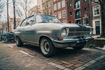 Old retro vintage car parked in European city.