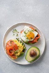 Scrambled eggs with smoked salmon and avocado on toast , Breakfast food