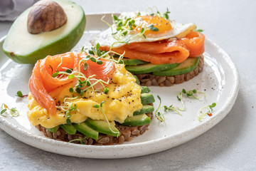 Scrambled eggs with smoked salmon and avocado on toast , Breakfast food