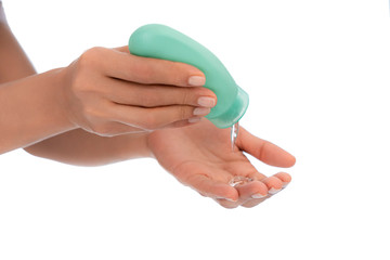 Woman hands, on White empty isolated background using hand sanitizer small personal squeezable green dispenser alcohol gel, coronavirus quarantine, covid-19