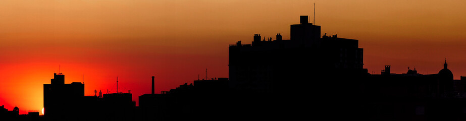 Fototapeta na wymiar cityscape of Porto Alegre on the sunset with Gasômetro and Catedral Metropolitana, red sky