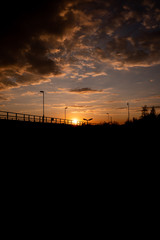 
sunset in prague near train tracks. Street lamps are visible