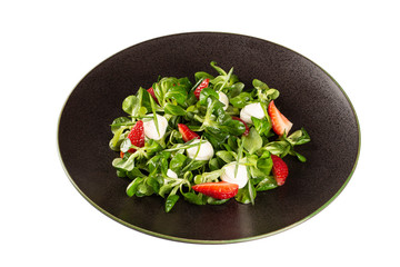 Fresh spring salad with strawberries, mozzarella cheese and herbs. Healthy food, natural products. Do it yourself at home.